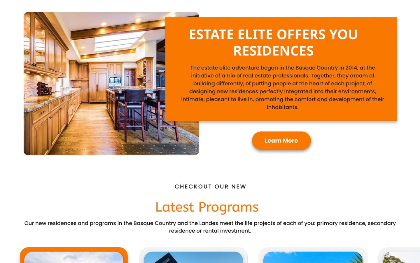 EstateElite Orange real estate website home page with four orange feature icons above a kitchen interior photograph and an orange text panel.